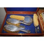 A mahogany box containing a silver dressing table