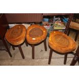 Three rustic wooden three legged stools