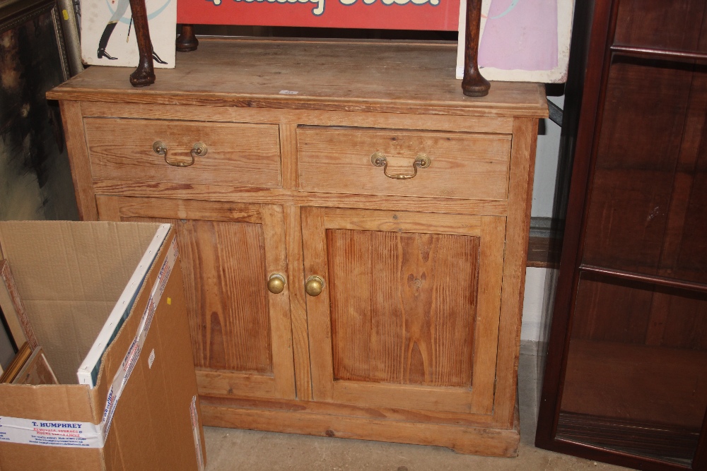 A stripped pine side board fitted two drawers