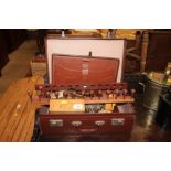 A brown leather suitcase and contents