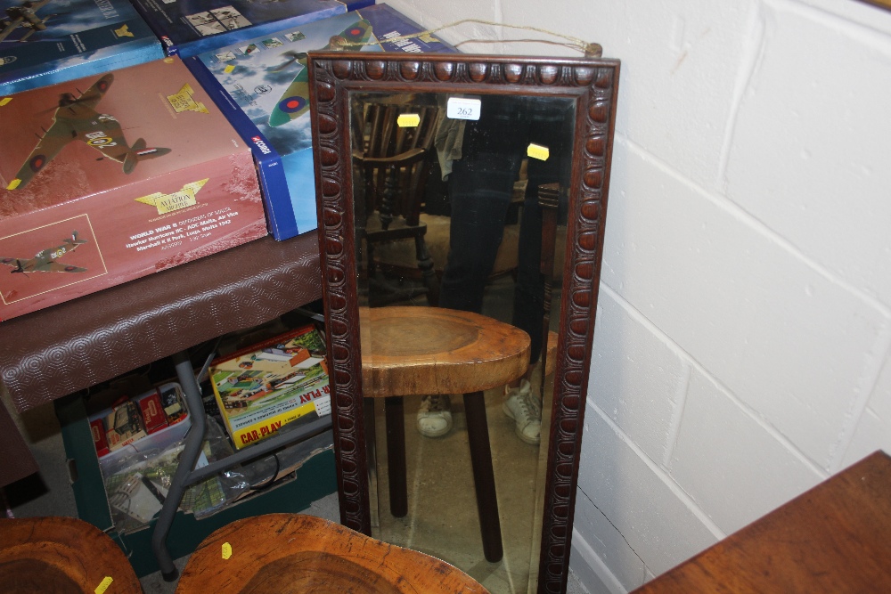 An oak framed oblong and bevel edged mirror