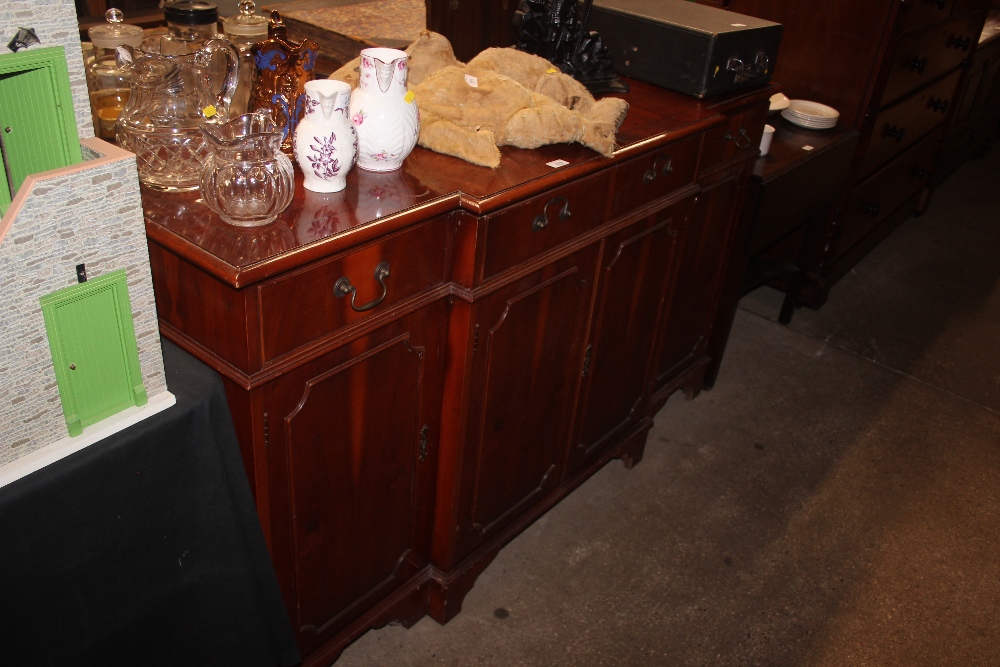 A reproduction yew wood break front sideboard