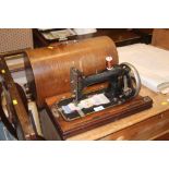 An old hand sewing machine in wooden case