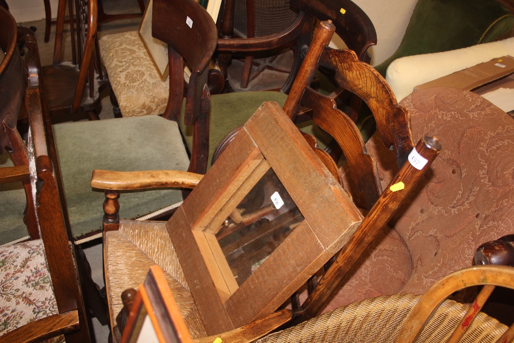 An oak ladder back and rush seated rocking chair