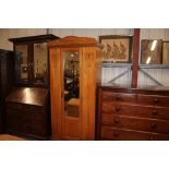 An Edwardian satin wood single door wardrobe