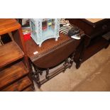 An oak gate leg tea table raised on barley twist s