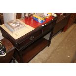 An oak effect and red leather topped two tier side