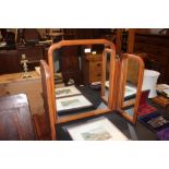 A wooden framed triptych dressing table mirror