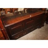 An antique oak mule chest fitted two drawers below