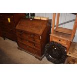 A Georgian oak and elm bureau fitted two short ove