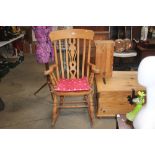 A beech slat back rocking chair