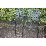 A pair of metal garden armchairs