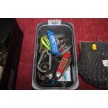 A tub of various key rings, pen knives etc.