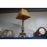 A brass table lamp and shade