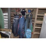 Three golf bags and contents