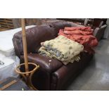 A brown leather upholstered reclining settee