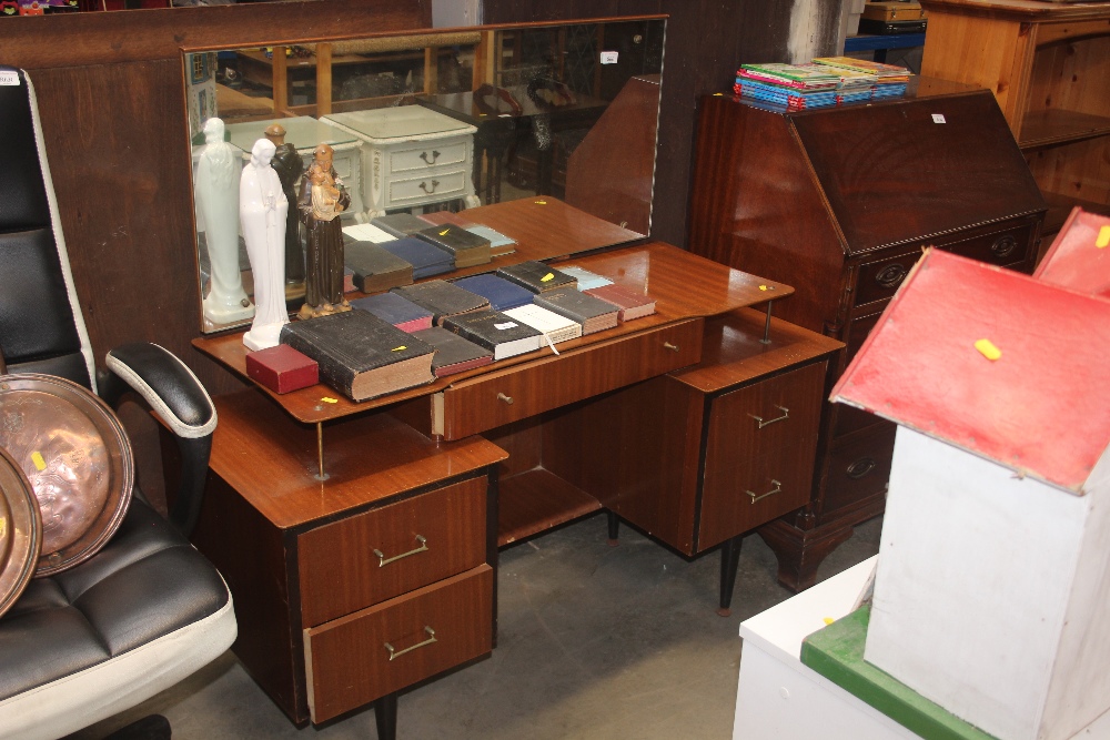 A teak effect dressing table fitted five drawers