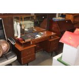 A teak effect dressing table fitted five drawers