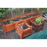 An oblong garden planter and a pair of wooden plan