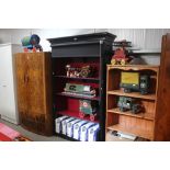 A black painted open fronted bookcase