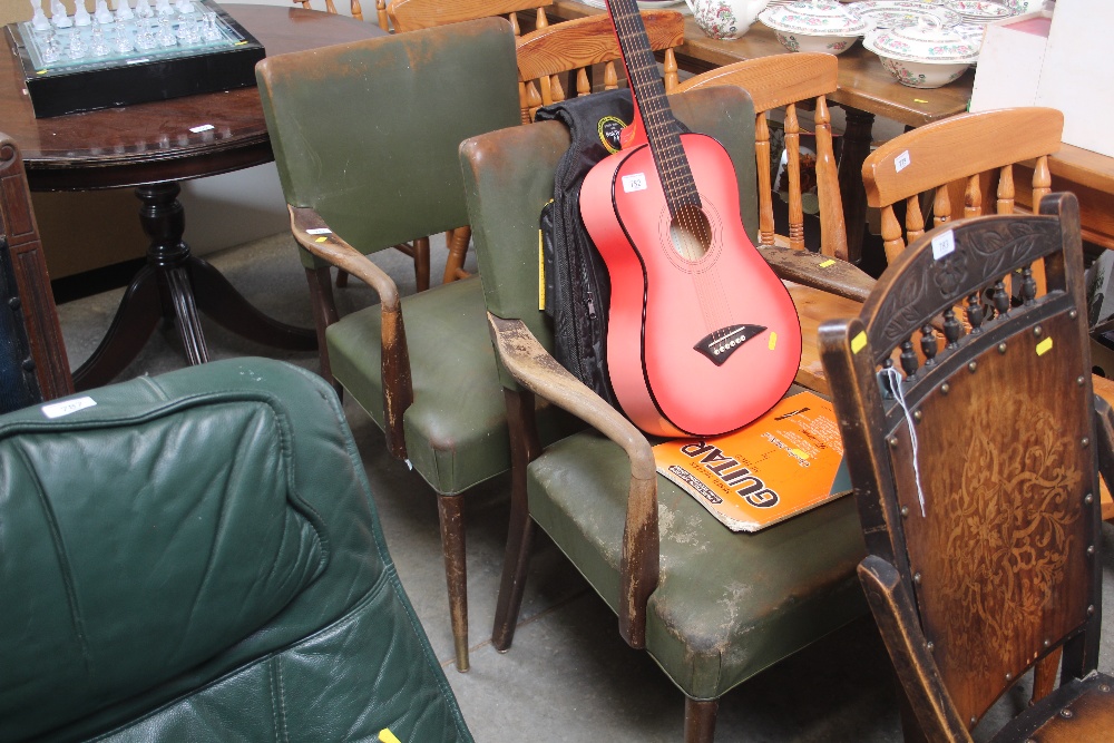 A pair of cream leather upholstered armchairs