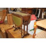 A small oak drop leaf table with green leather ins