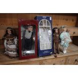 Two boxed dressed dolls and three others