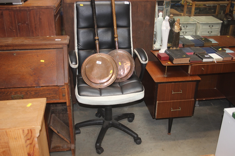 A leather upholstered swivel office chair