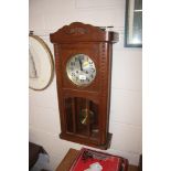 An oak cased wall clock