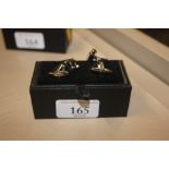 A pair of novelty cuff-links in the form of hand t