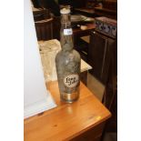 An Old Scotch Whiskey bottle and contents of coins