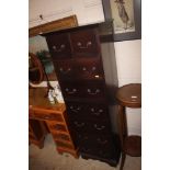 A tall hardwood nine drawer chest of narrow propor