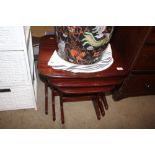 A nest of three mahogany occasional tables