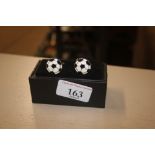 A pair of novelty cuff-links in the form of footba