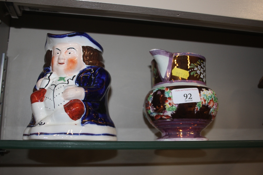 A Victorian copper lustre jug decorated with a bas