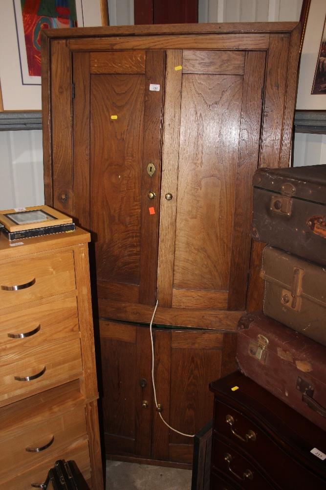 A 19th Century elm corner cupboard