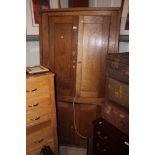 A 19th Century elm corner cupboard