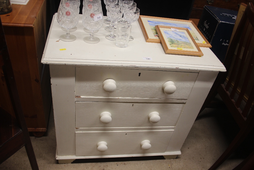 A white painted three drawer chest