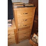 A pair of ash three drawer bedside chests