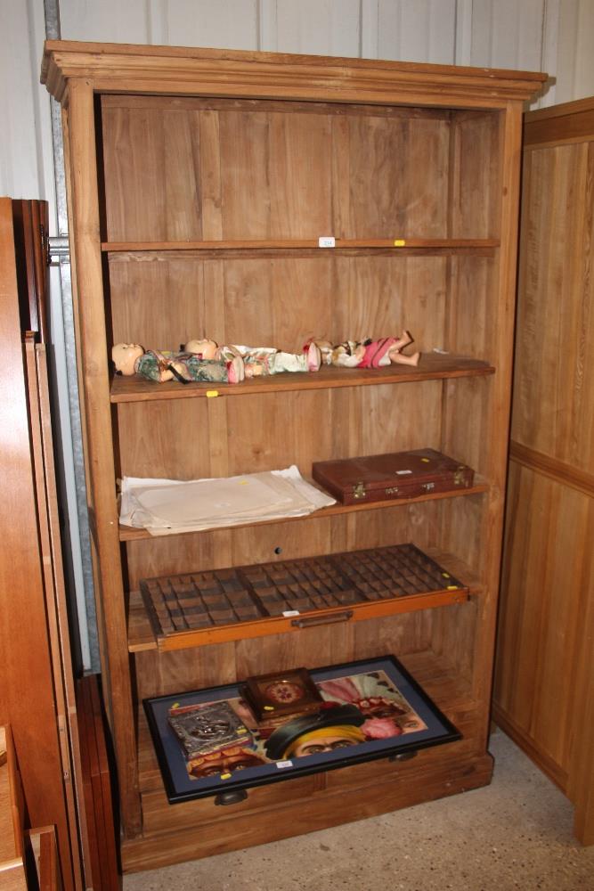 A tall hardwood bookcase fitted two drawers below