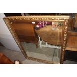 A large gilt framed and bevelled edged mirror