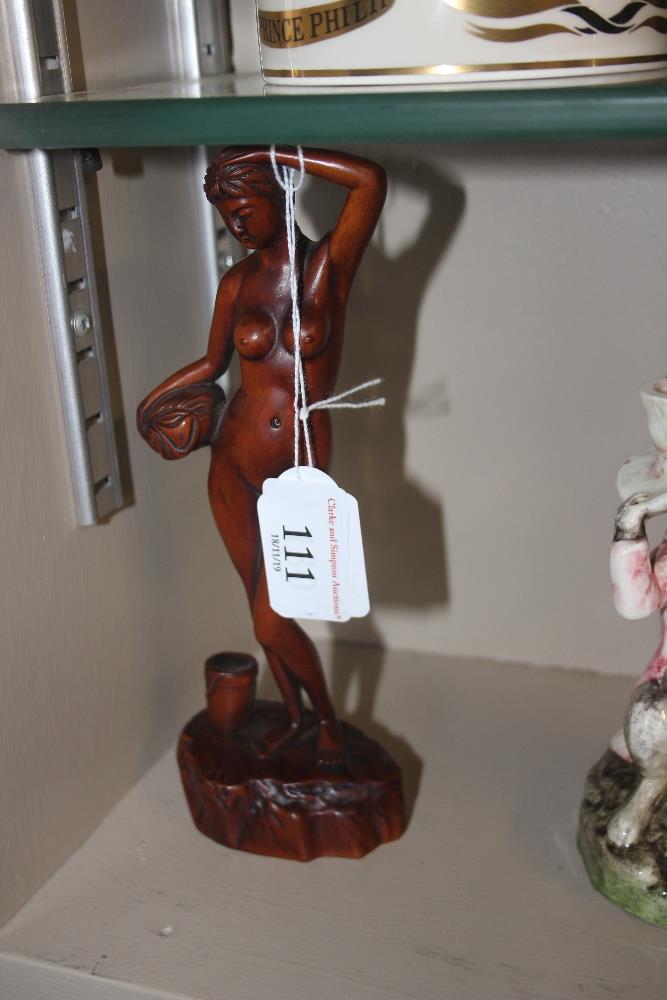 A carved wooden figure in the form of a naked girl