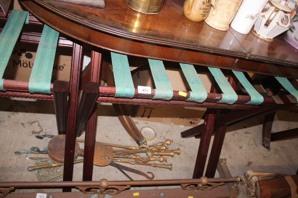 A wooden folding luggage stand