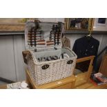 A wicker picnic basket and contents