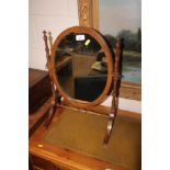 A mahogany swing framed mirror