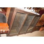 A large oak and glazed three section bookcase