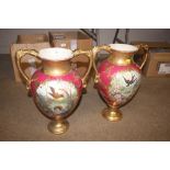 A pair of large gilt decorated twin handled vases,