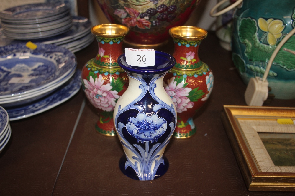 A pair of Closonnié floral decorated vases; and an