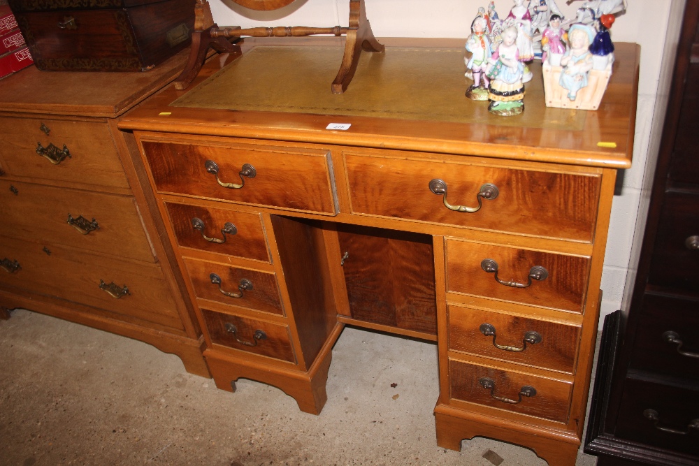 A reproduction yew wood twin pedestal writing desk