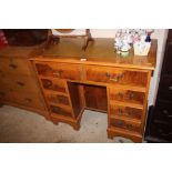 A reproduction yew wood twin pedestal writing desk